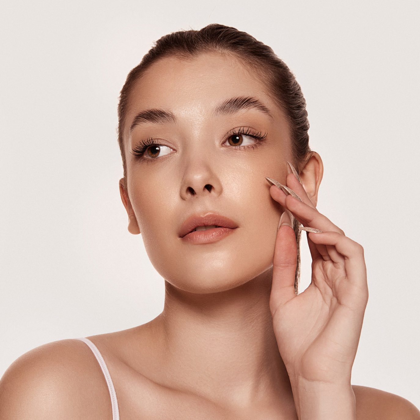 Become a cosmetic treatment model at Dr. Owlia Aesthetics — woman with clear, luminous skin