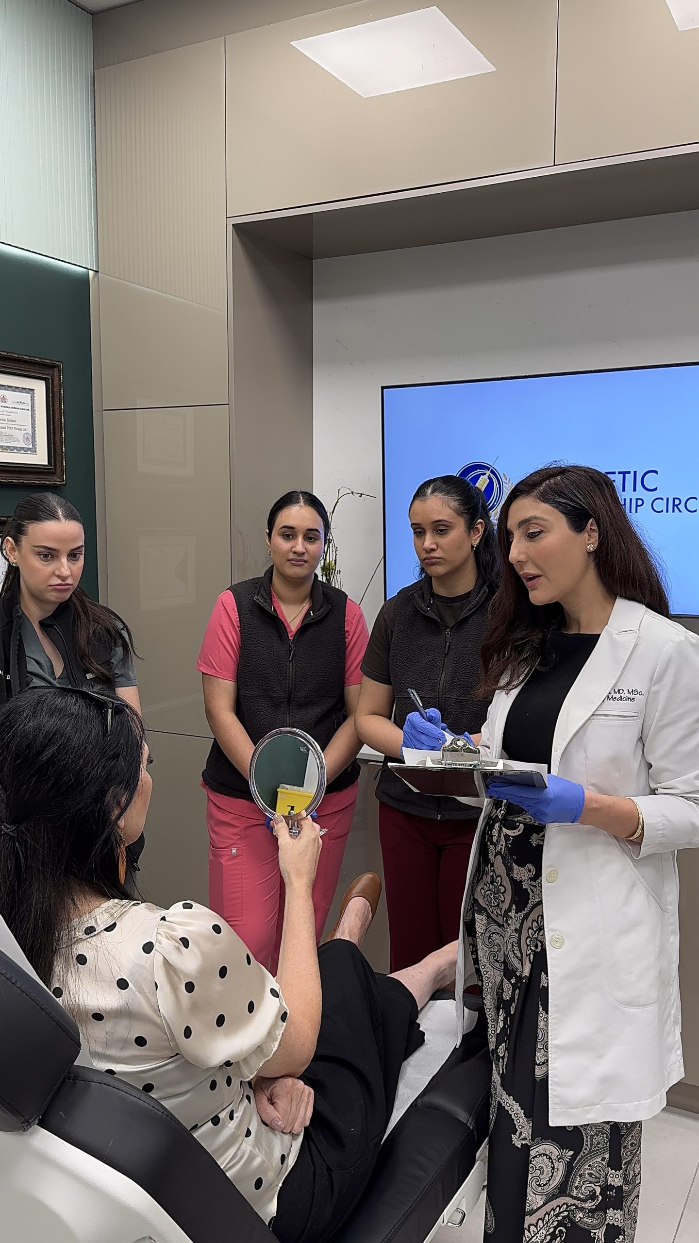 Aesthetic complications management course — Dr. Aida Owlia teaching a small group of injectors
