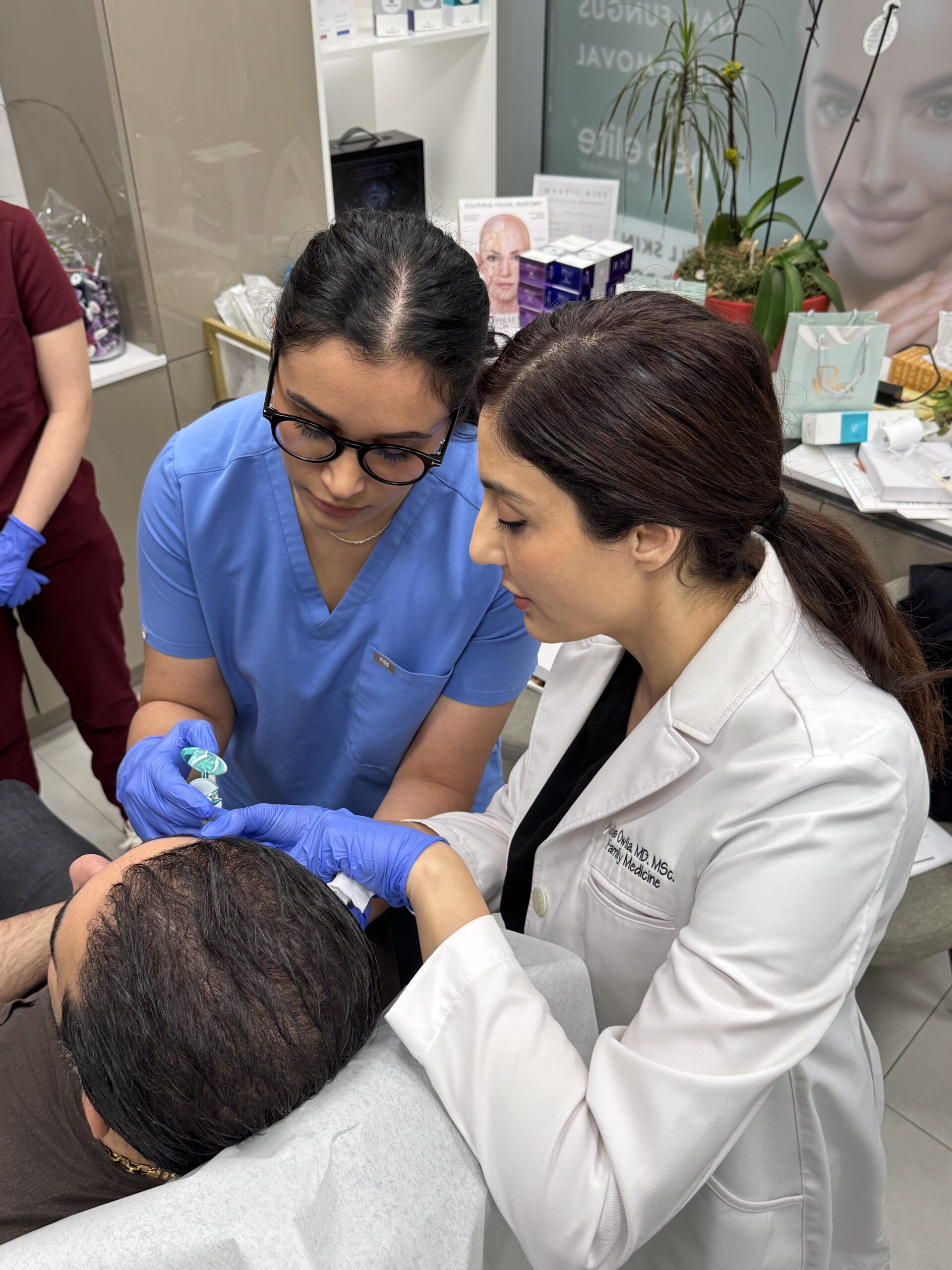 Master Class hands-on injector training — Dr. Aida Owlia supervising a trainee treating a patient